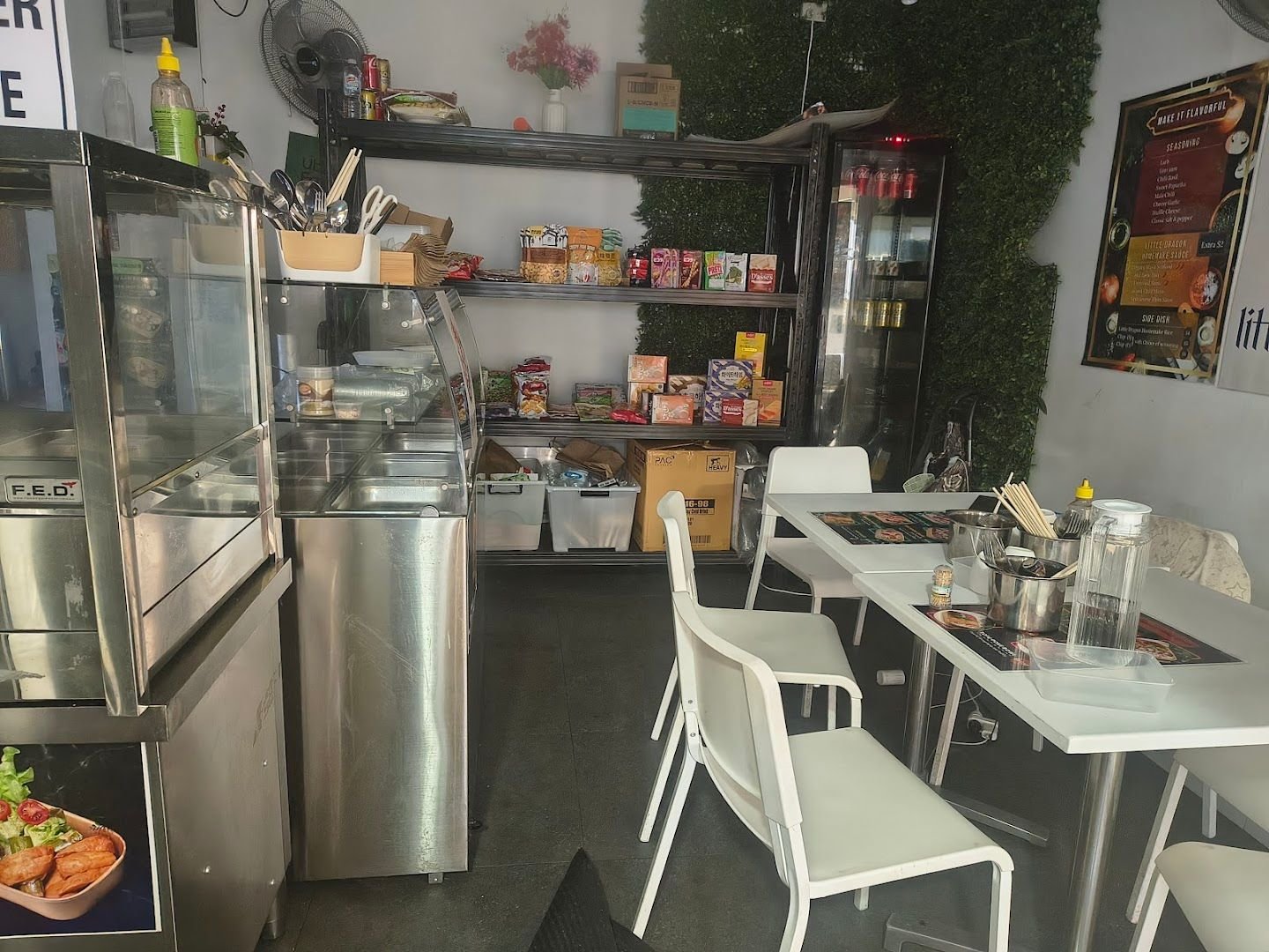 Small Little Dragon Thai Street Food counter with white dine-in tables